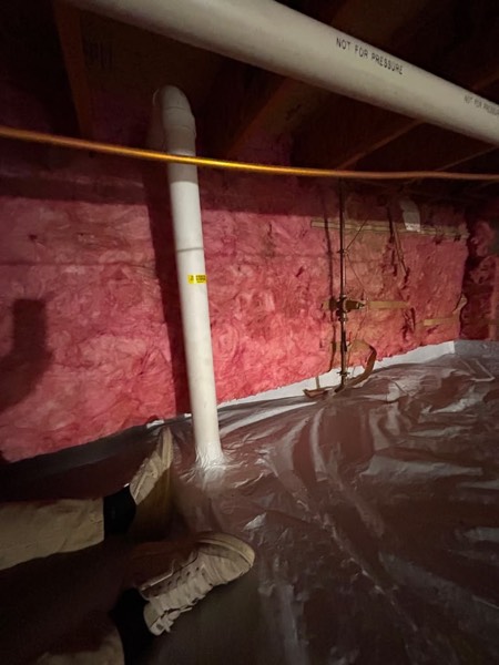 Crawl space sealed with a vapour barrier and insulated, radon suction pipe in place